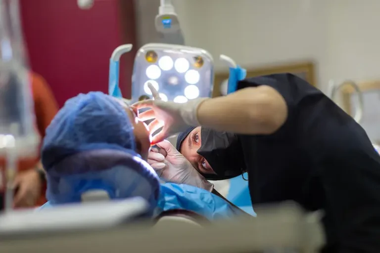 A dental surgeon performs bone grafting on a patient.
