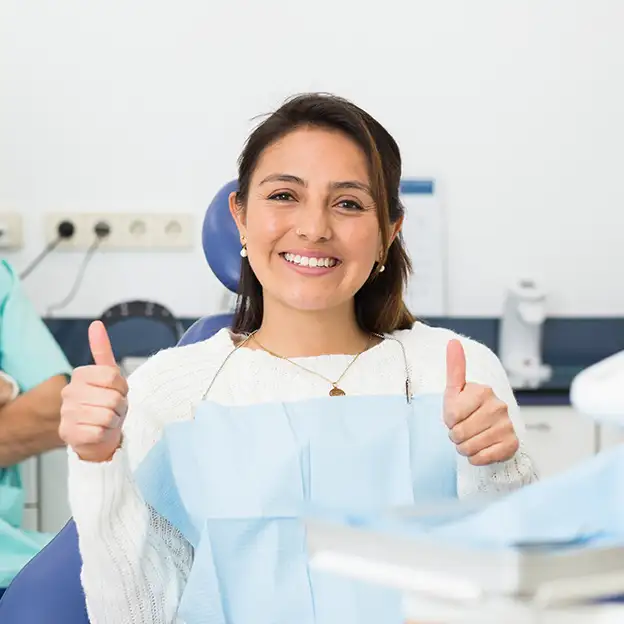 Dental implant patient with two thumbs up